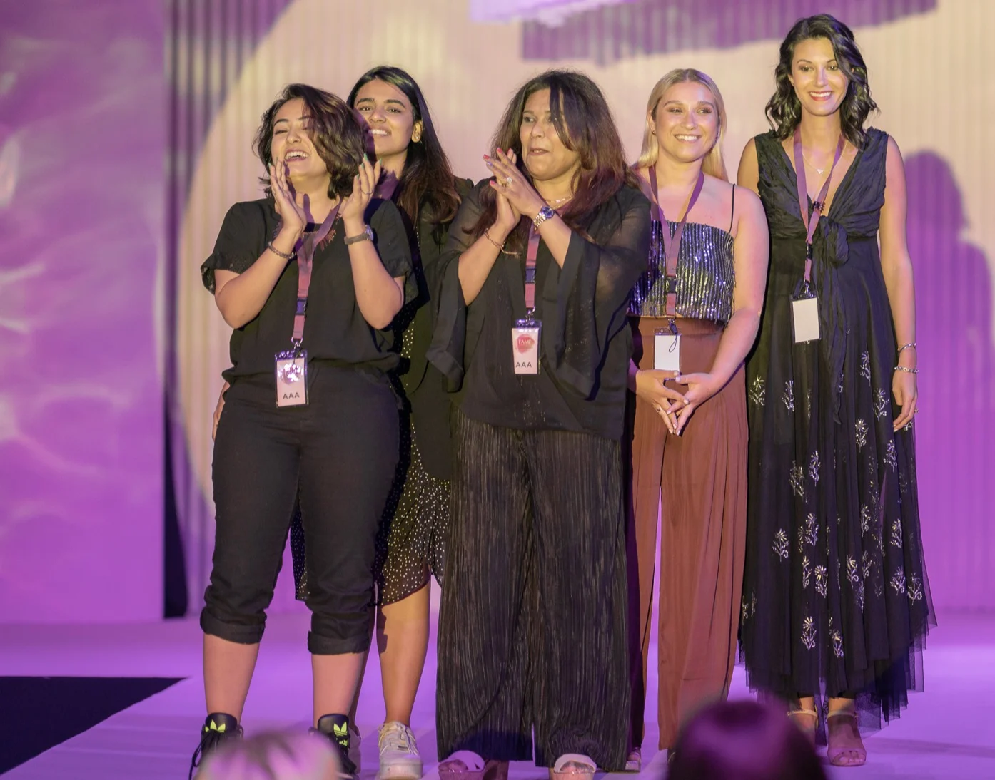Four women standing together at an event